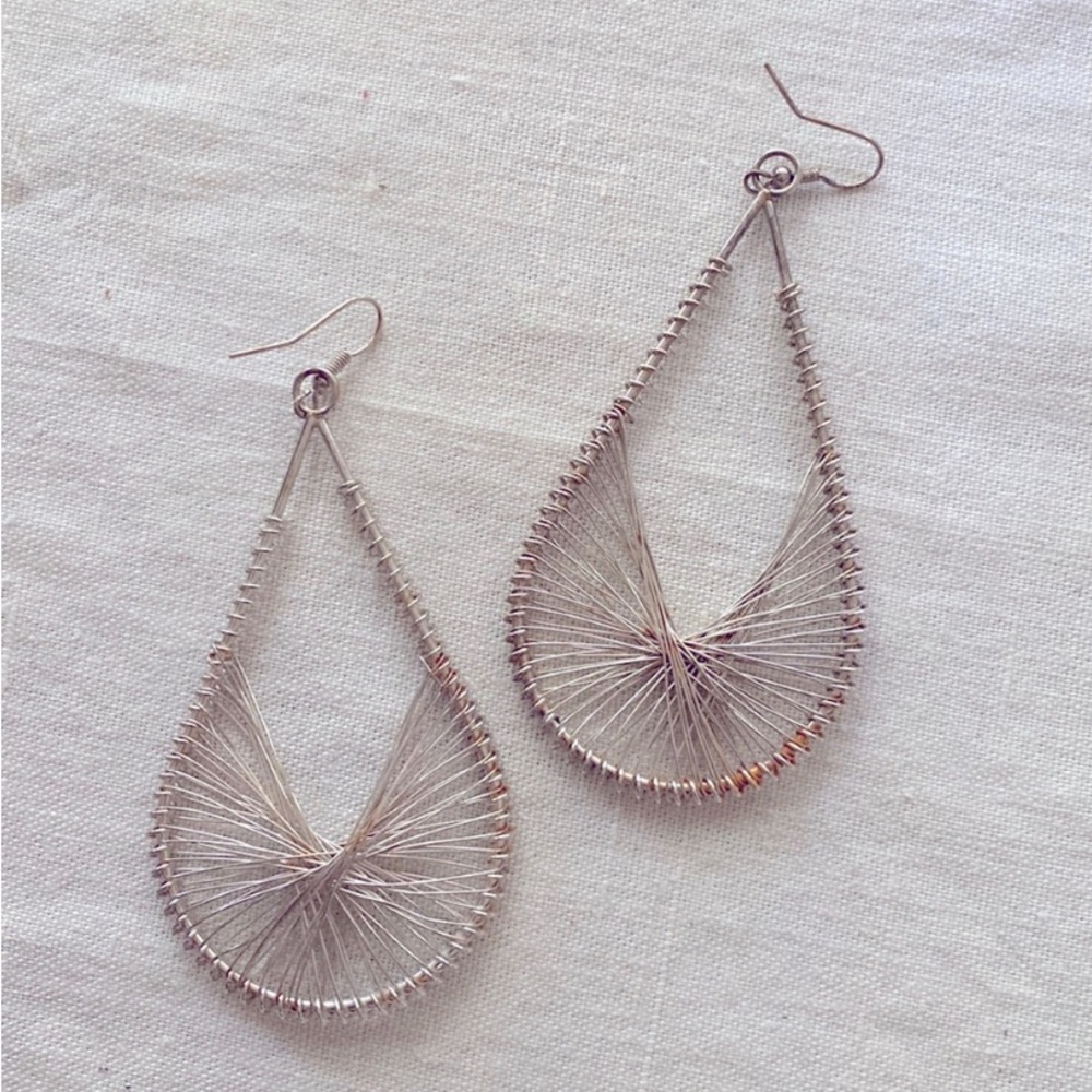 Large silver wire statement earrings.